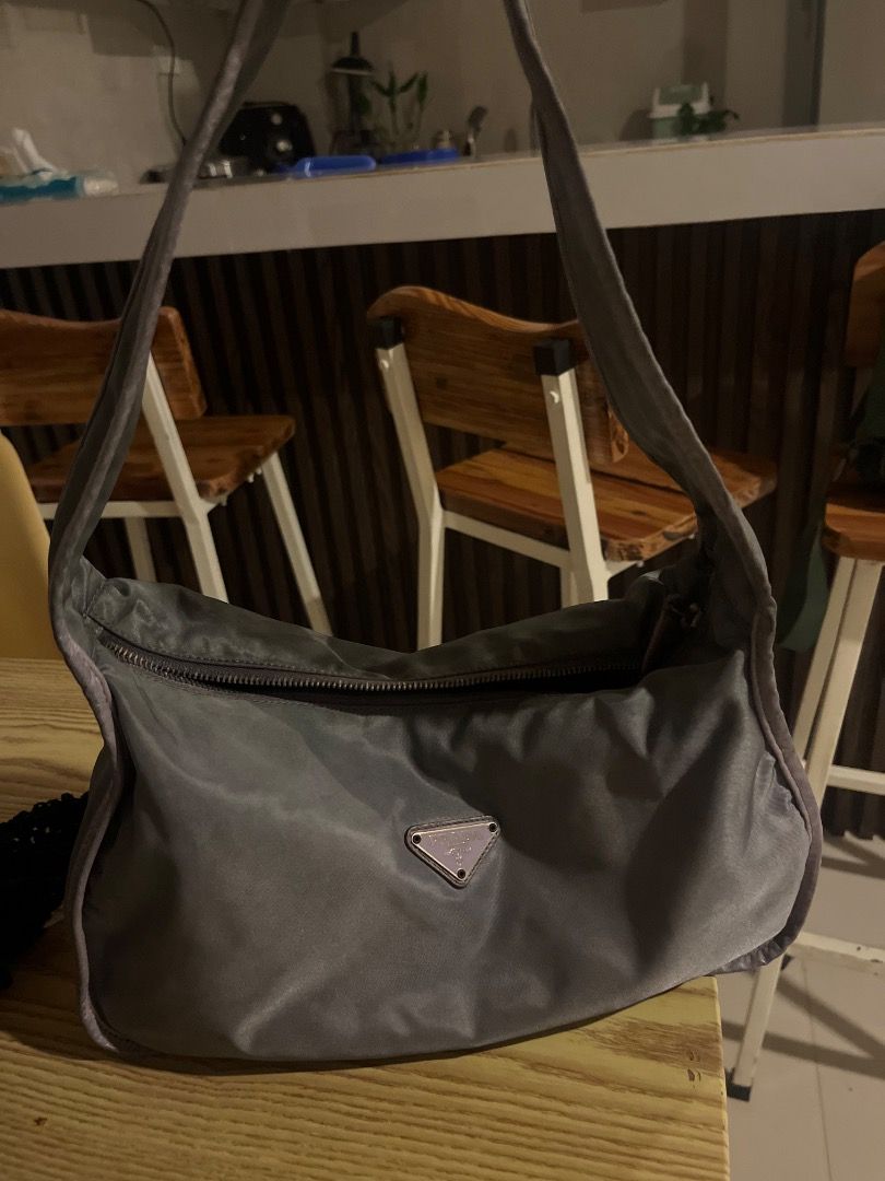 Prada Nylon Backpack & Shoulder Bag - Green & Grey (Category: Luxury Bags & Wallets) located in Manila. Submitted by dmaker_closet (Listing ID 1452468963, Image 3). Description: - Authentic Prada nylon bag set - Includes: 1 green backpack with drawstring closure and front pocket, 1 grey shoulder bag - Lightweight and practical for daily use - Ideal for travel or everyday errands.