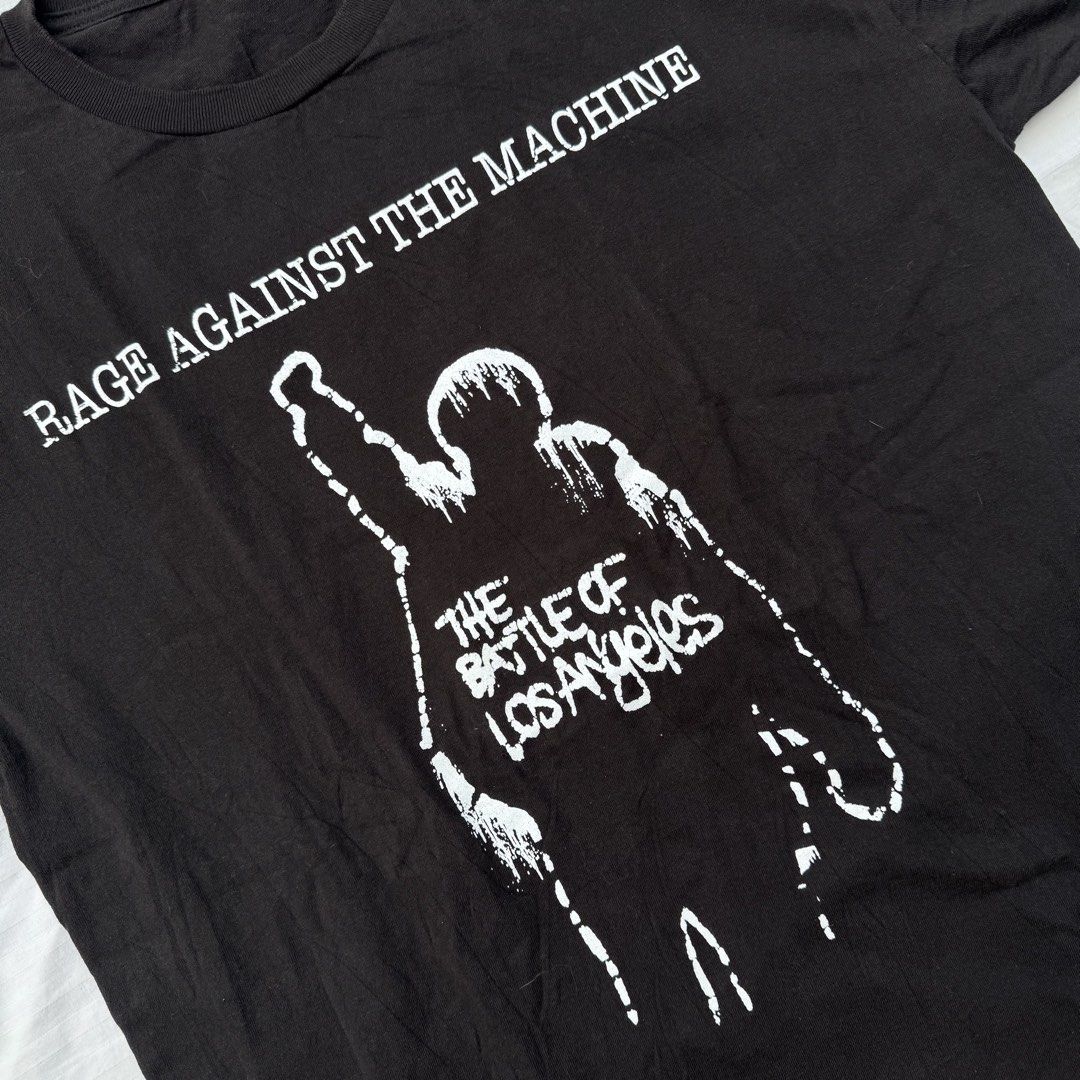 RAGE AGAINST THE MACHINE (Category: Tshirts & Polo Shirts ) located in Pasig City. Submitted by jaaard (Listing ID 1452503328, Image 2). Description: - Black t-shirt featuring Rage Against The Machine's 'The Battle of Los Angeles' album art. - size L 22x28.5 Cut tag - Iconic graphic print of a raised fist on the front. - Classic crew neck and short sleeves. - A must-have for any fan of the band..