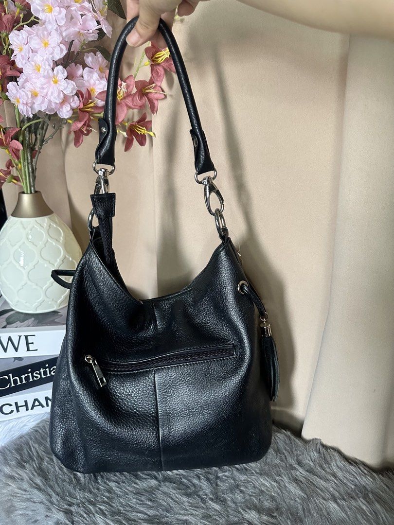 Rangrang hobo black bag (Category: Shoulder Bags) located in Rizal. Submitted by stuffbuyph (Listing ID 1452352136, Image 2). Description: - Stylish black pebbled leather hobo bag - Convenient zippered pocket on the back - Handy smaller zippered pocket on the front - Eye-catching tassel detail on one side - Secure interior zippered compartment - Elegant silver hardware accents - Comfortable shoulder strap for easy carrying.