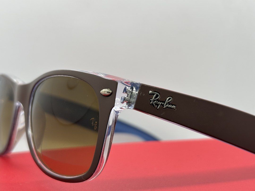 Ray-Ban Wayfarer Sunglasses Brown Frame (Category: Sunglasses & Eyewear) located in Bacoor. Submitted by cryptl (Listing ID 1452323072, Image 3). Description: - Classic Ray-Ban Wayfarer sunglasses - Brown frame with clear arms - Brown gradient lenses - Great for everyday wear - Minor signs of use on frame, lenses are clear - A timeless accessory.
