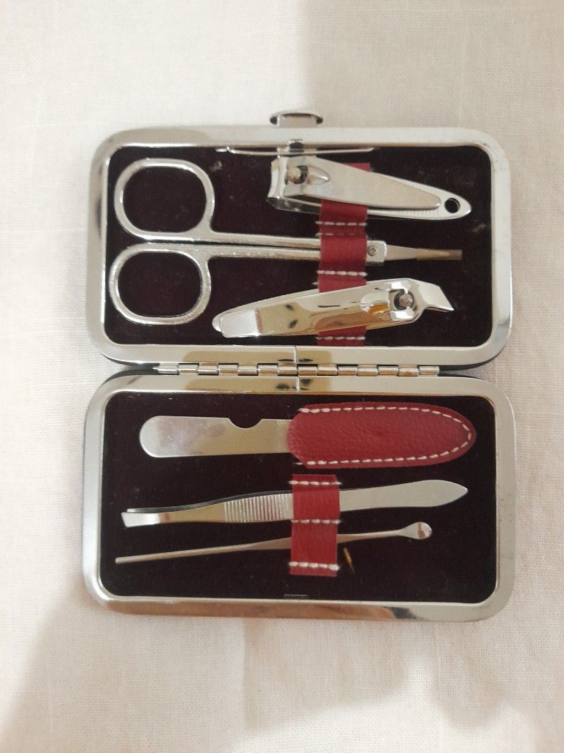 Red Leather Manicure Set (Category: Hands & Nails) located in Las Pinas. Submitted by redwine1798 (Listing ID 1452481132, Image 1). Description: - Compact manicure set in a stylish red faux leather case. - Includes essential stainless steel tools: nail clippers, scissors, tweezers, cuticle pusher, and nail file. - Features a chic diagonal black stripe with white stitching on the case. - Secure snap closure keeps everything in place. - Ideal for t