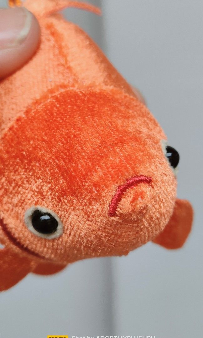 Ryukin Goldfish Plush Bag Charm Keychain (Category: Plushies & Soft Toys) located in Taguig. Submitted by adopt.my.plush.ph (Listing ID 1452407235, Image 2). Description: Ryukin Goldfish Plush Keychain featuring a velvety orange body and a ball chain Brand/Manufacturer: Kitan Club Character/Variety: Ryukin Goldfish (known for its characteristic humpback and long, flowing fins) Size: Approximately 4 inches (11 cm to 14 cm) Attachment: White plasti