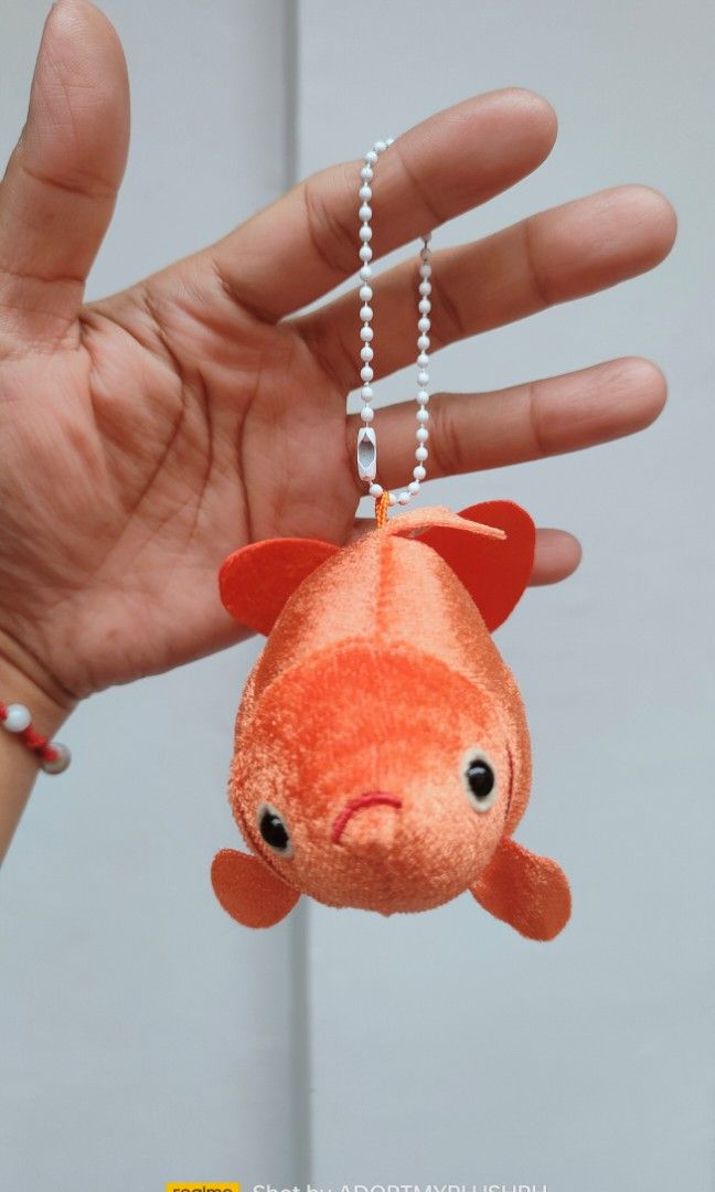 Ryukin Goldfish Plush Bag Charm Keychain (Category: Plushies & Soft Toys) located in Taguig. Submitted by adopt.my.plush.ph (Listing ID 1452407235, Image 3). Description: Ryukin Goldfish Plush Keychain featuring a velvety orange body and a ball chain Brand/Manufacturer: Kitan Club Character/Variety: Ryukin Goldfish (known for its characteristic humpback and long, flowing fins) Size: Approximately 4 inches (11 cm to 14 cm) Attachment: White plasti