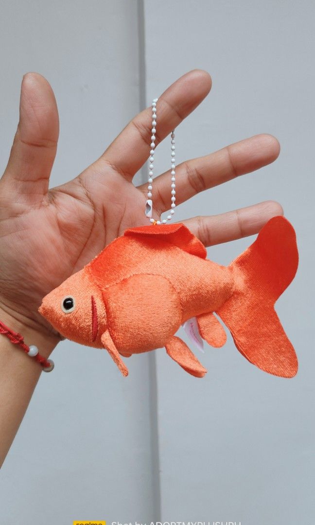 Ryukin Goldfish Plush Bag Charm Keychain (Category: Plushies & Soft Toys) located in Taguig. Submitted by adopt.my.plush.ph (Listing ID 1452407235, Image 1). Description: Ryukin Goldfish Plush Keychain featuring a velvety orange body and a ball chain Brand/Manufacturer: Kitan Club Character/Variety: Ryukin Goldfish (known for its characteristic humpback and long, flowing fins) Size: Approximately 4 inches (11 cm to 14 cm) Attachment: White plasti