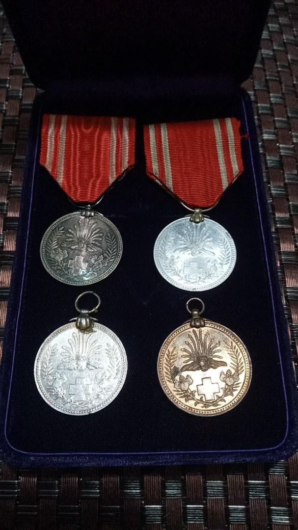 Set of 4pcs WW2 silver medals (Category: Currency) located in Imus. Submitted by chadrich_05 (Listing ID 1452380893, Image 1). Description: 2pcs silver medals 1 aluminum and 1 bronze - Set of 4 medals: 2 silver-toned, 2 bronze-toned. - Each medal features a central emblem with a wreath border. - Medals hang from red ribbons with silver stripes. - Presented in a dark blue velvet-lined box. - Ideal for collectors..