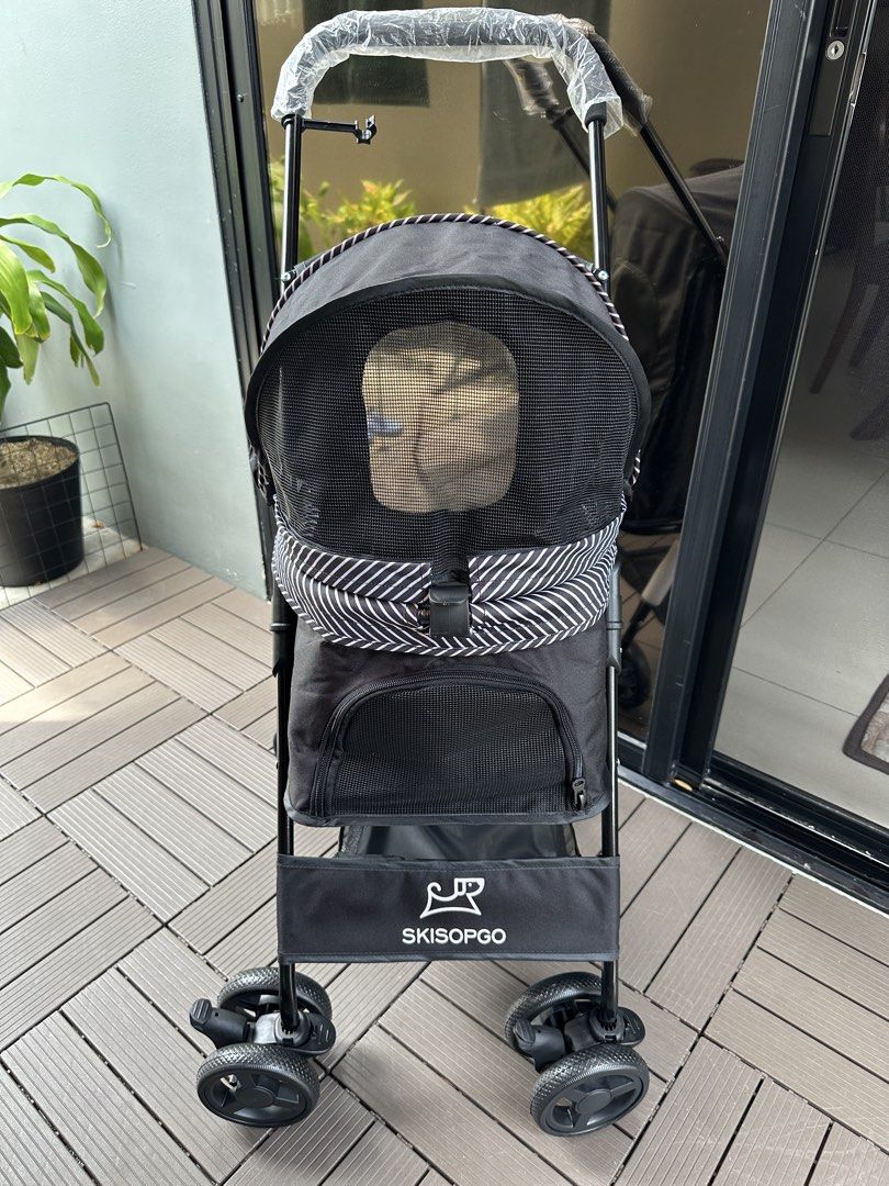 SKISOPGO Pet Stroller - Black (Category: Homes & Other Pet Accessories) located in Cavite. Submitted by jazz.shop (Listing ID 1452348460, Image 3). Description: - Black pet stroller from SKISOPGO - Canopy with mesh windows for ventilation - Convenient storage basket underneath - Swivel wheels for effortless maneuvering - Comfortable plastic-covered handlebar - Weight Capacity up to 15kgs.