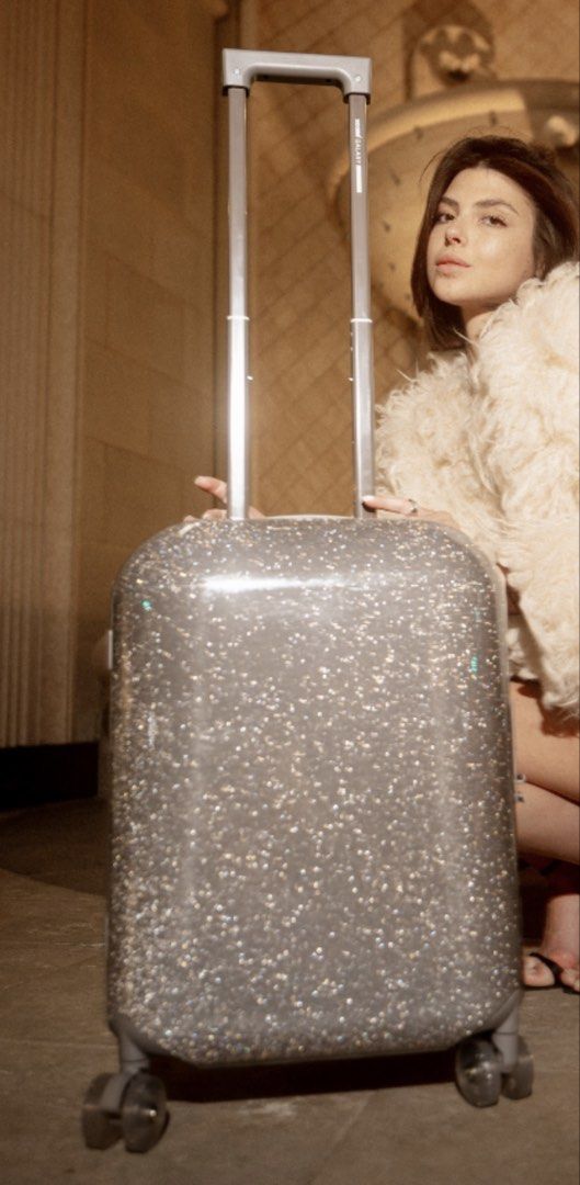 Sparkly Glitter Carry-On Luggage (Category: Luggage) located in Paranaque City. Submitted by porshamee (Listing ID 1452332764, Image 2). Description: - Grey carry-on suitcase with a full glitter finish - Retractable handle and smooth spinner wheels for easy maneuverability - TSA-approved lock for security - Shows some scuffs and scratches from normal use - Perfect for your next trip!.