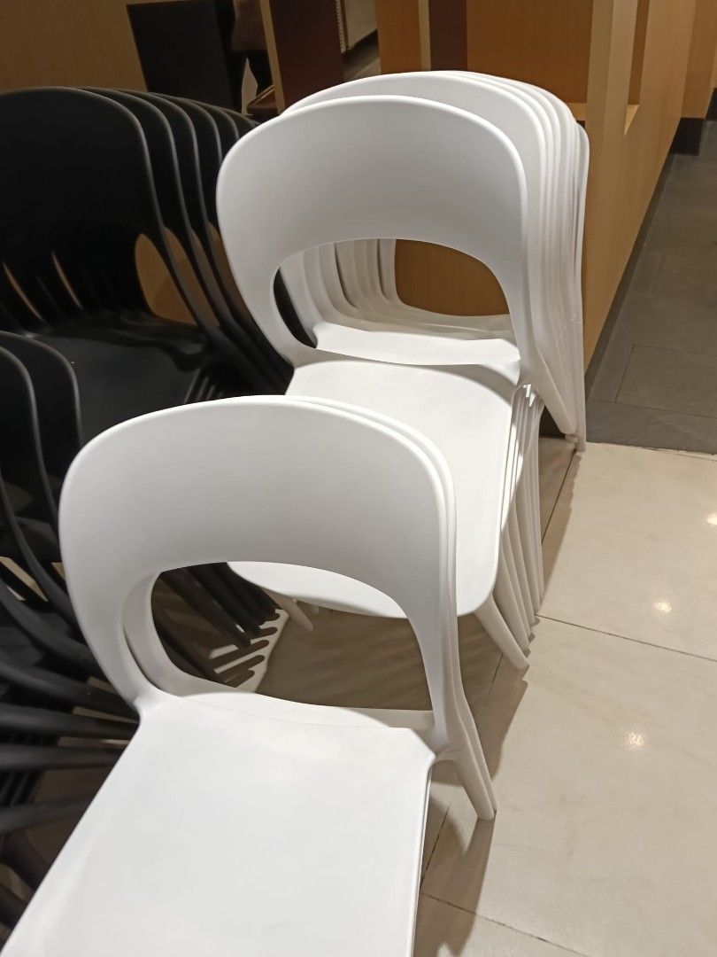 Stackable White Plastic Chairs (Category: Chairs) located in Singapore. Submitted by s.t.i (Listing ID 1452455653, Image 1). Description: - 19 Chairs Available - Easy stacking for convenient storage - Simple and modern design - Durable plastic construction - Ideal for events, cafes, or extra home seating - Black chairs available separately.