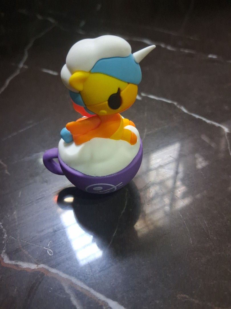 Tokidoki Simone Legno Figure C-WW2516 (Category: Designer & Blind Box Toys) located in Manila. Submitted by beardedbot (Listing ID 1452329600, Image 2). Description: - Cute Tokidoki figure designed by Simone Legno. - Model: C-WW2516 - Features a purple base. - Character is yellow and white with blue and orange accents. - Ideal for collectors or as a fun desk accessory. - Small and collectible item..