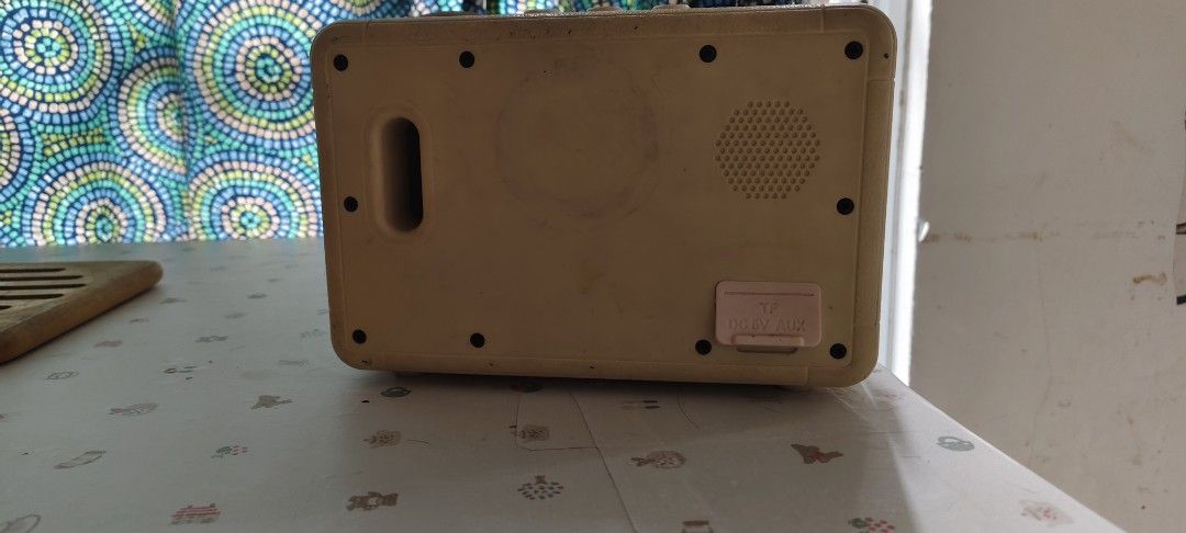 Vintage Style Portable Speaker with Leather Strap (Category: Soundbars, Speakers & Amplifiers) located in Bulacan. Submitted by babz30261 (Listing ID 1452422081, Image 2). Description: Retro-looking portable speaker. Has a cream-colored body and a mesh front. Comes with a leather strap for carrying. The back shows an AUX input and a DC 5V input. Great for music on the go. Some signs of wear visible..