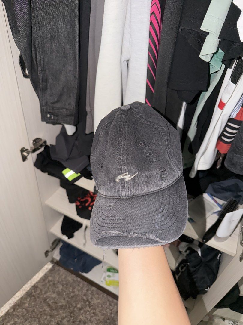 Whose Studio Hat (Category: Caps & Hats) located in Singapore. Submitted by yjkrz1 (Listing ID 1452428171, Image 1). Description: - Grey baseball cap - Distressed look with rips and frayed edges - Small logo on the front - Adjustable strap at the back - Ideal for casual wear.