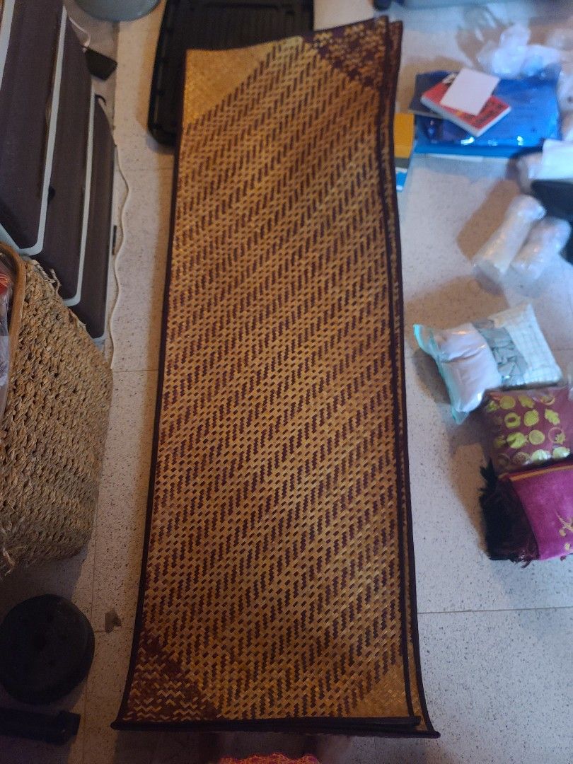 Woven Mat (Category: Carpets, Mats & Flooring) located in Pasig City. Submitted by kyla792980 (Listing ID 1452347842, Image 2). Description: - Long woven mat with a geometric pattern - Made of natural fibers - Features a dark border - Ideal for floor covering or decorative use - Rolls up easily for convenient storage - Dimensions: Approximately [insert length] by [insert width] good for picnic can make like bag.