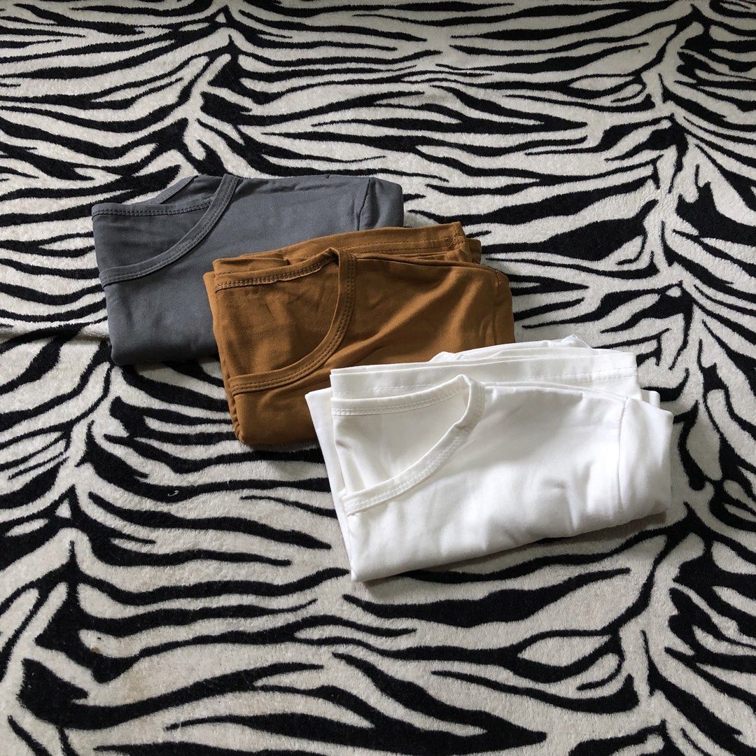 3 Basic Tops (Category: Shirts) located in Muntinlupa City. Submitted by ksclocollection (Listing ID 1452573373, Image 2). Description: 3 pcs basic tops (never been used, almost new) fit to med to large girlies color: White, Mustard, Gray All for 150.