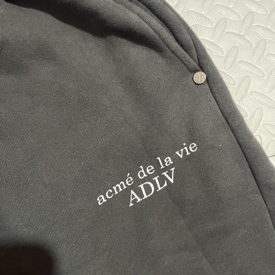Acme de la Vie ADLV Grey Sweatpants (Category: Joggers) located in Zamboanga. Submitted by selvege (Listing ID 1452616971, Image 2). Description: - Grey sweatpants from Acme de la Vie (ADLV) - Elastic waistband with drawstring for adjustable fit - Cuffed ankles for a snug feel - ADLV logo printed on the left leg - Two convenient side pockets - Small ADLV logo tag on the back pocket - Comfortable and stylish design.