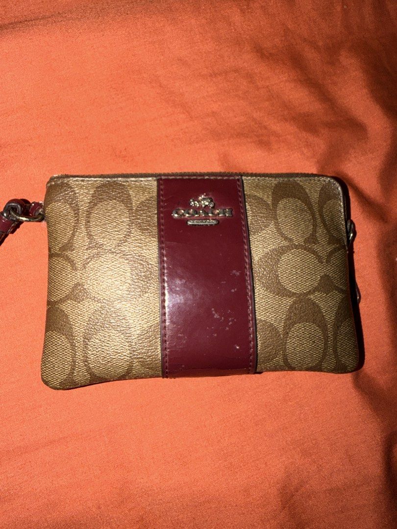 Authentic Preloved Coach Corner Zip Wristlet Leather Maroon (Category: Luxury Bags & Wallets) located in Quezon City. Submitted by closetbymira_ (Listing ID 1452657044, Image 2). Description: Authentic Have scratches and peeling leather Visible signs of usage.