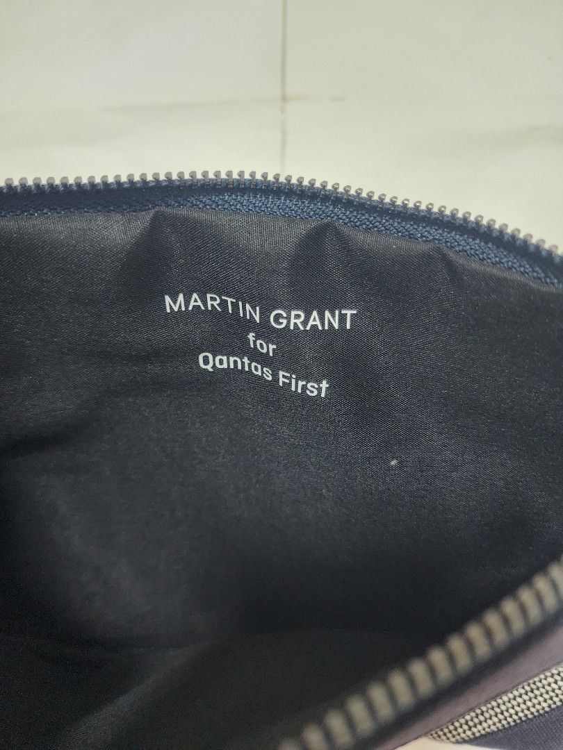 Authentic Qantas First Class Amenity Pouch x Martin Grant (Navy/Grey) (Category: Accessory Holder, Box & Organizers) located in Pasig City. Submitted by jam1ekow (Listing ID 1452682310, Image 3). Description: Brand / Partnership: Qantas Airways First Class x Martin Grant Color: Navy Blue, Grey, and Off-White Pattern: Textured birdseye / jacquard weave with vertical stripe detailing Material: Premium woven textile fabric with reinforced cotton-can
