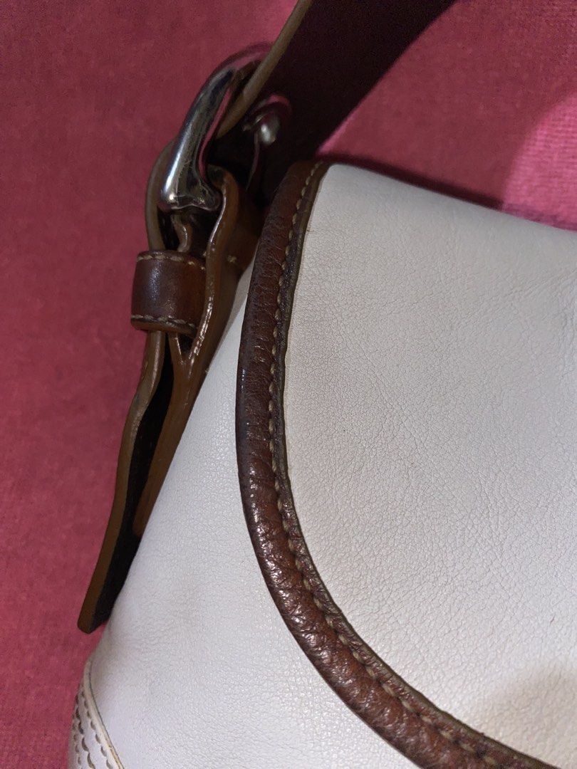 Authentic Vintage Coach White-Tan Soho || 5,500 LP! (Category: Luxury Bags & Wallets) located in Manila. Submitted by terimeovvth (Listing ID 1452544662, Image 3). Description: [Original listing got deleted:(] Loveee love this soho! My personal bag but I have to let her go—I need funds. Has signs of use. I will also send more details in DMs if interested! 💌 🤍🤎Details: - Off-White leather shoulder bag with brown leather trim - Features a buckle