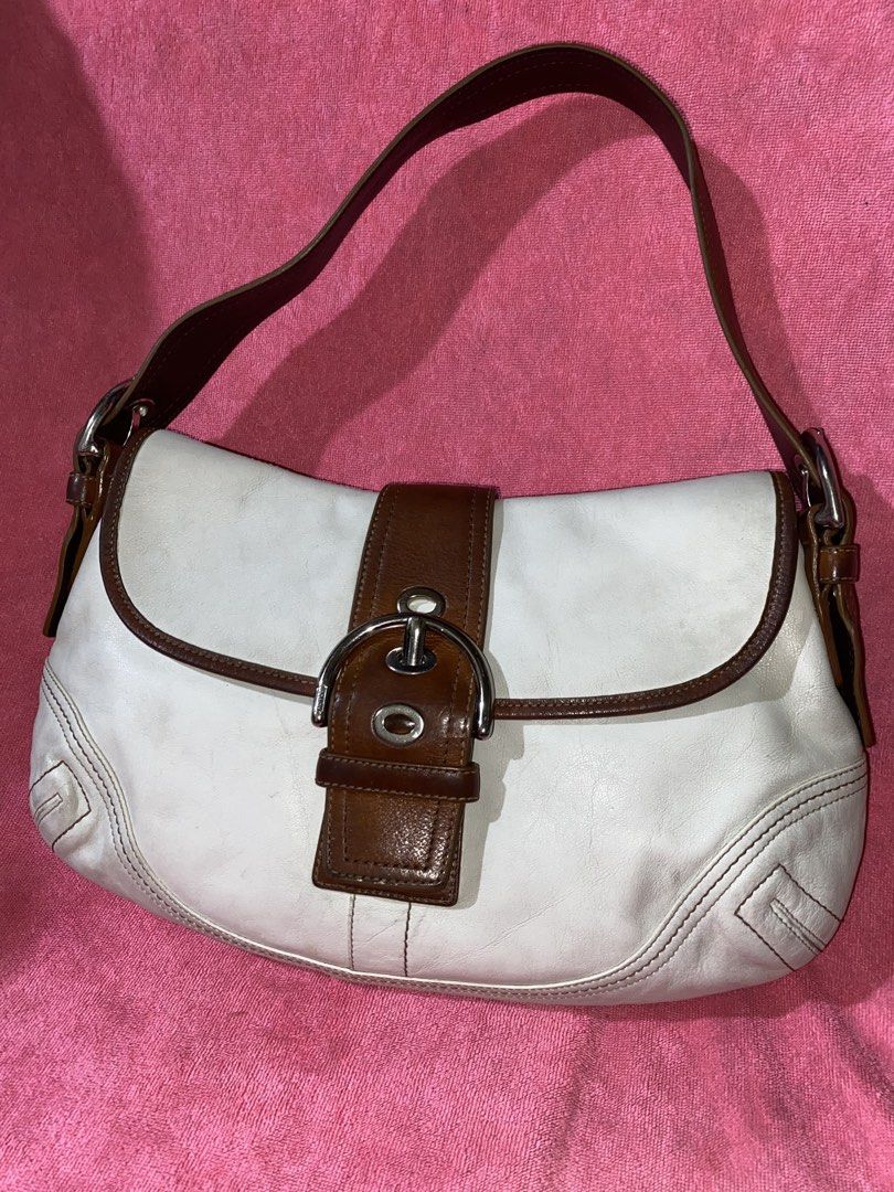 Authentic Vintage Coach White-Tan Soho || 5,500 LP! (Category: Luxury Bags & Wallets) located in Manila. Submitted by terimeovvth (Listing ID 1452544662, Image 1). Description: [Original listing got deleted:(] Loveee love this soho! My personal bag but I have to let her go—I need funds. Has signs of use. I will also send more details in DMs if interested! 💌 🤍🤎Details: - Off-White leather shoulder bag with brown leather trim - Features a buckle