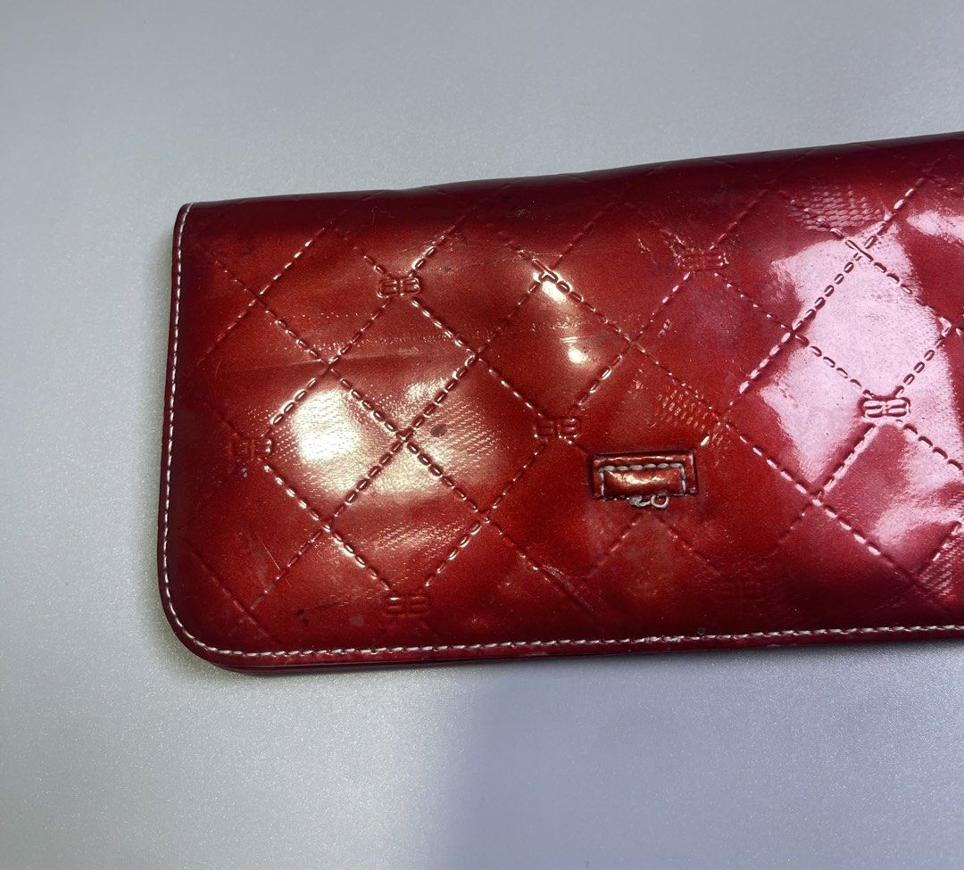 Baleciaga Wallet (Category: Wallets & Card holders) located in Zamboanga. Submitted by laffthrift_23 (Listing ID 1452677780, Image 3). Description: - Shiny red wallet with a stylish quilted pattern. - Secure snap closure. - Minor scuffs and scratches on the patent leather balexterior. - Interior is clean and well-maintained. - Plenty of life left, perfect for everyday use. - Need clean and restore - Stain.