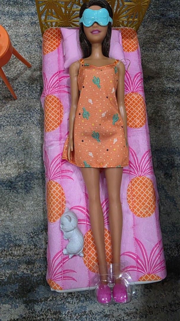 Barbie Doll Bed with Accessories and Doll (Category: Kids Toys) located in Manila. Submitted by chikawa3 (Listing ID 1452585685, Image 2). Description: - Barbie doll included, wearing a cute orange dress and eye mask. - Features a bed with fun pineapple print bedding. - Comes with a small dog figure. - Includes a side table with accessories. - Also includes pink slippers and a small plant. - Ideal for imaginative and creative play..