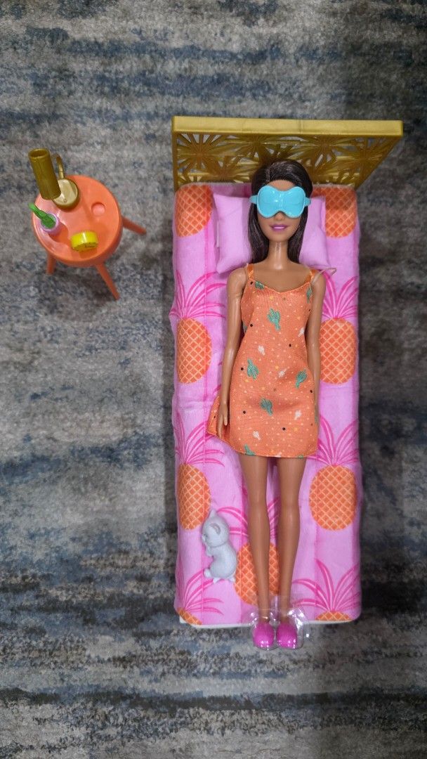 Barbie Doll Bed with Accessories and Doll (Category: Kids Toys) located in Manila. Submitted by chikawa3 (Listing ID 1452585685, Image 1). Description: - Barbie doll included, wearing a cute orange dress and eye mask. - Features a bed with fun pineapple print bedding. - Comes with a small dog figure. - Includes a side table with accessories. - Also includes pink slippers and a small plant. - Ideal for imaginative and creative play..