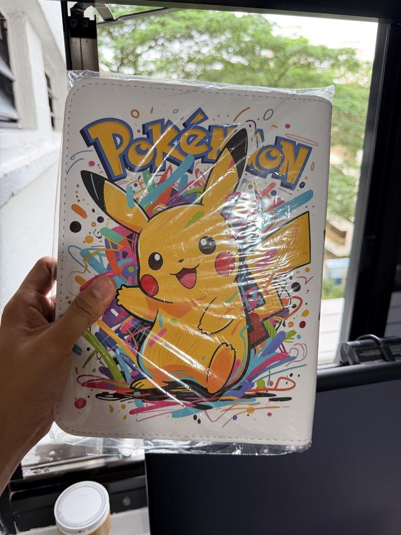 Binders (Category: Trading Cards Accessories) located in Singapore. Submitted by rerlon (Listing ID 1452606164, Image 6). Description: Pokemon Theme Binders Multiple Binders Available Design 1 - Picture 1&2 Design 2 - Picture 3&4 Design 3 - Picture 5&6 All binders are top loadable, 4 grids, side inserts, 20 pages, 200 card slots in total! Great for collectors.