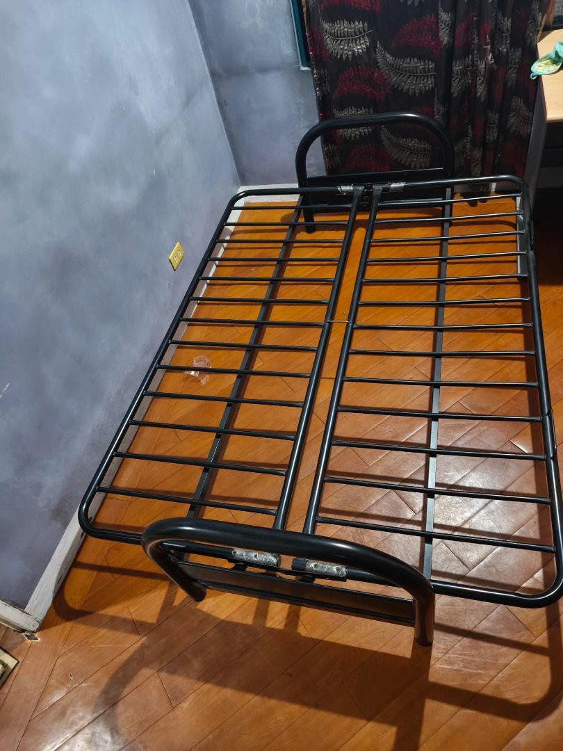 Black Metal Sofa Bed Frame (Category: Bed Frames & Mattresses) located in Quezon City. Submitted by espie106 (Listing ID 1452621105, Image 2). Description: - Sturdy black metal bed frame - Slatted base for mattress support - Simple design with curved head and footboards - Ready for a new home - Mattress not included.