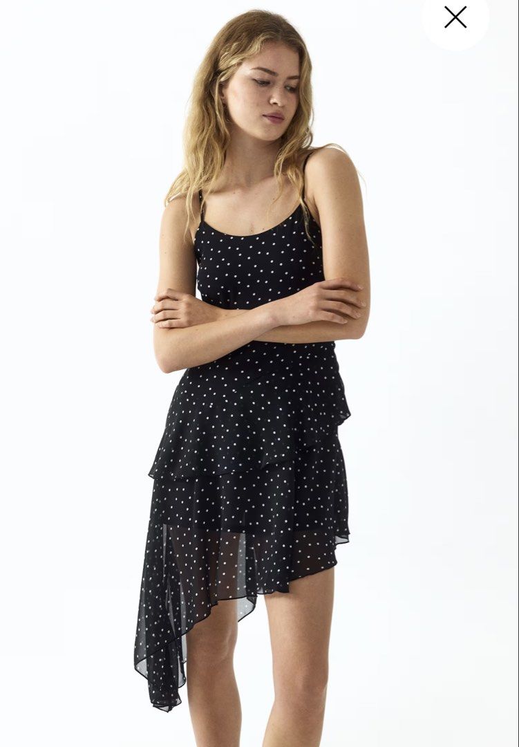 Black Polka Dot Ruffle Asymmetrical Mini Dress (Category: Dresses) located in Manila. Submitted by paperthread (Listing ID 1452582882, Image 2). Description: - Black mini dress with white polka dots - Thin spaghetti straps - Tiered, asymmetrical ruffle hem - Lightweight and flowy fabric - Perfect for warm weather - Easy to dress up or down for any occasion.