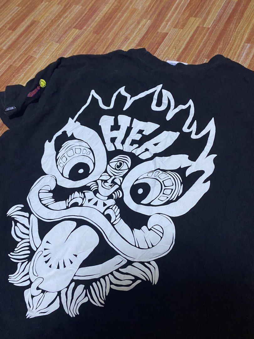 Black T-shirt with Graphic Print (Category: Tshirts & Polo Shirts ) located in Manila. Submitted by drip-from-thrift (Listing ID 1452510394, Image 3). Description: - Black t-shirt - Features a cool graphic print on the front pocket and back - Made with good quality material - Ideal for casual everyday wear.