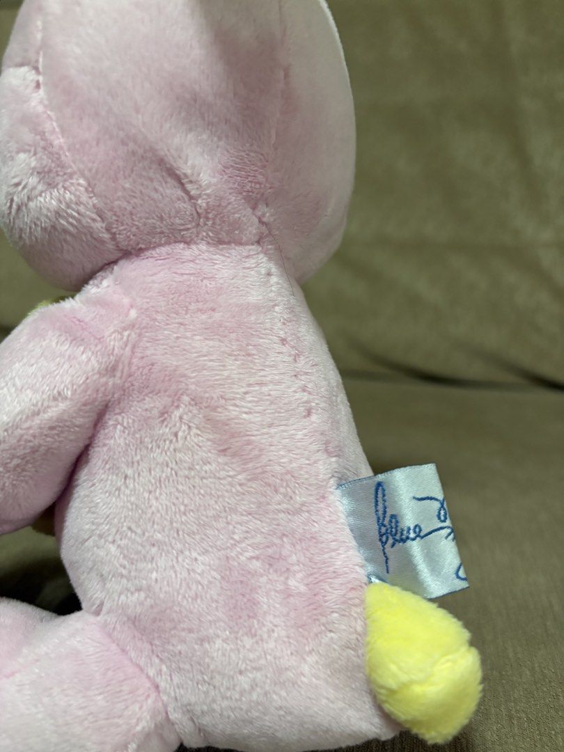 Blue Magic pink bunny plush toy (early 2000's) (Category: Plushies & Soft Toys) located in Cavite. Submitted by marissa0_0 (Listing ID 1452685221, Image 2). Description: - Adorable pink bunny plush toy from Blue Magic. - Early 2000s vintage collectible. - Features a yellow flower with a blue center. - Cute green eyes and a pink nose. - Ideal for collectors or as a charming decoration..
