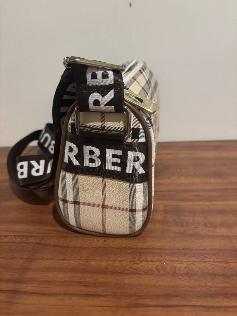 Burberry Nova Check Crossbody Bag with Logo Strap (Category: Luxury Bags & Wallets) located in Pasig City. Submitted by lhengay (Listing ID 1452651794, Image 2). Description: - Classic Burberry crossbody bag - Iconic Nova Check pattern - Burberry logo repeated on the strap - Secure zipper closure - Interior pockets for organization - Ideal for everyday wear.