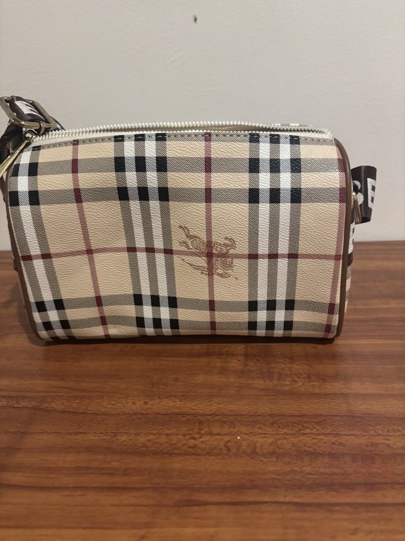 Burberry Nova Check Crossbody Bag with Logo Strap (Category: Luxury Bags & Wallets) located in Pasig City. Submitted by lhengay (Listing ID 1452651794, Image 3). Description: - Classic Burberry crossbody bag - Iconic Nova Check pattern - Burberry logo repeated on the strap - Secure zipper closure - Interior pockets for organization - Ideal for everyday wear.