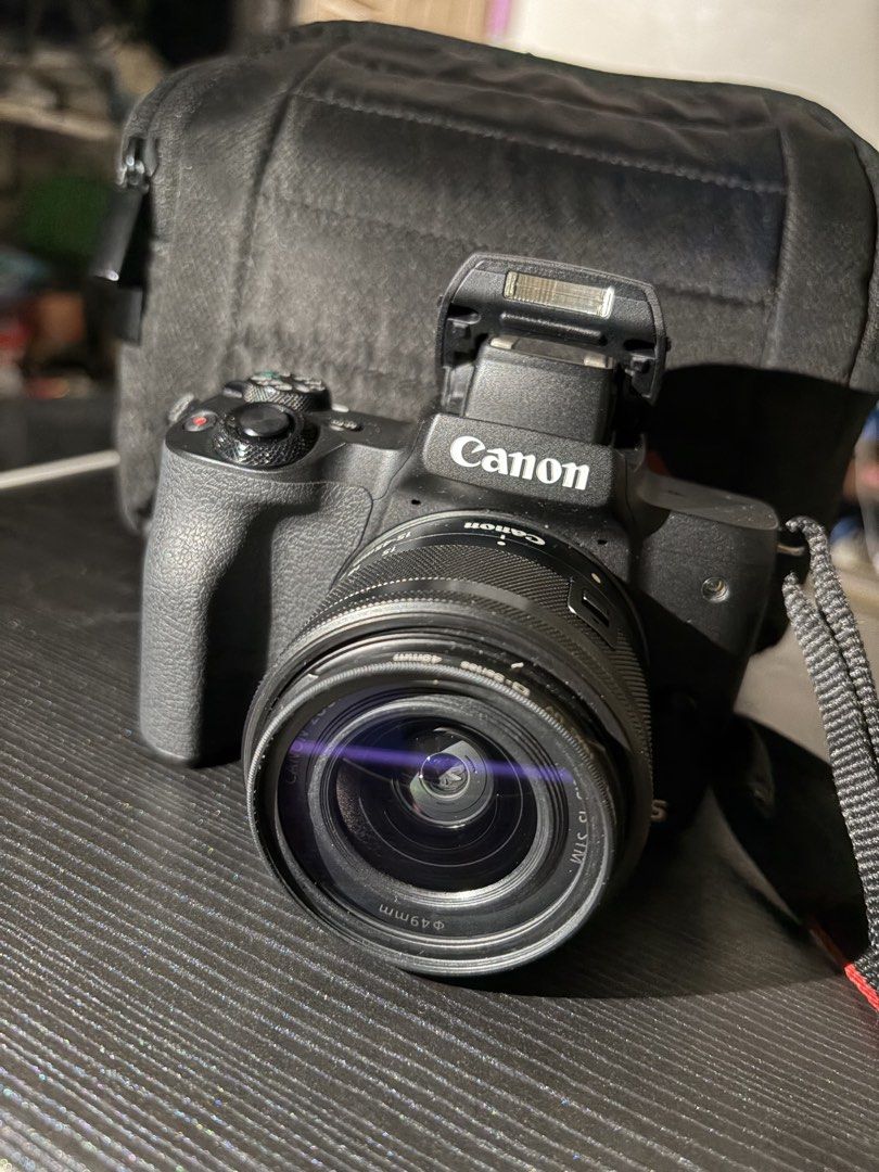 Canon EOS M50 Mark II Mirrorless Camera (Category: Cameras) located in Quezon City. Submitted by pingg26 (Listing ID 1452634496, Image 2). Description: - Canon EOS M50 mark II mirrorless camera - kit lens 15-45mm - 2 batteries - charger and cord - bag - neck strap - 32 gb sandisk ultra SD card - SD card reader - screen protector - box and manuals *see photos for camera conditions *good as new, barely use.