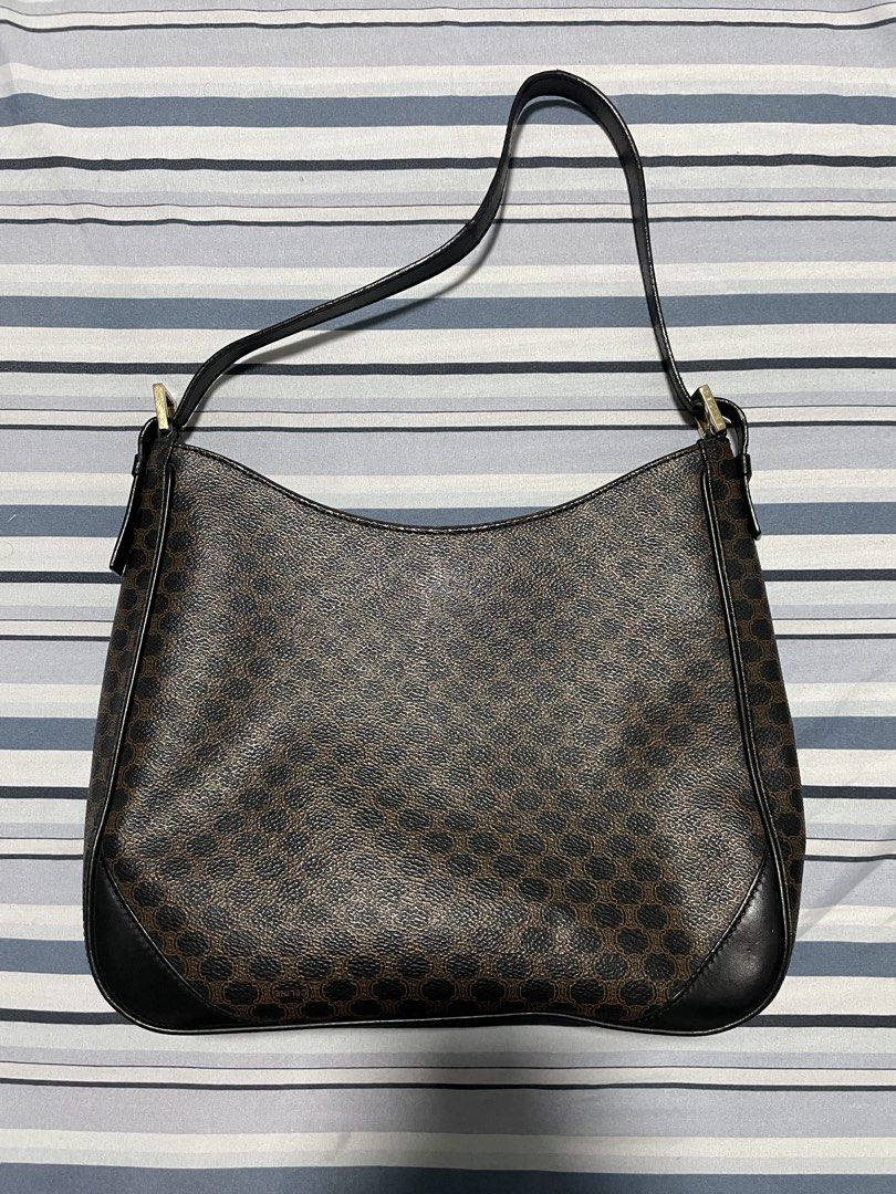 Celine Macadam Hobo Bag (Category: Luxury Bags & Wallets) located in Calapan. Submitted by lucasthrifts (Listing ID 1452607566, Image 1). Description: - Brand: Celine - Model: Macadam - Type: Hobo Shoulder Bag - Design: Iconic Macadam print - Condition: Great - Color: Brown/Black -Issue: Leather Sling cracks but still sturdy .