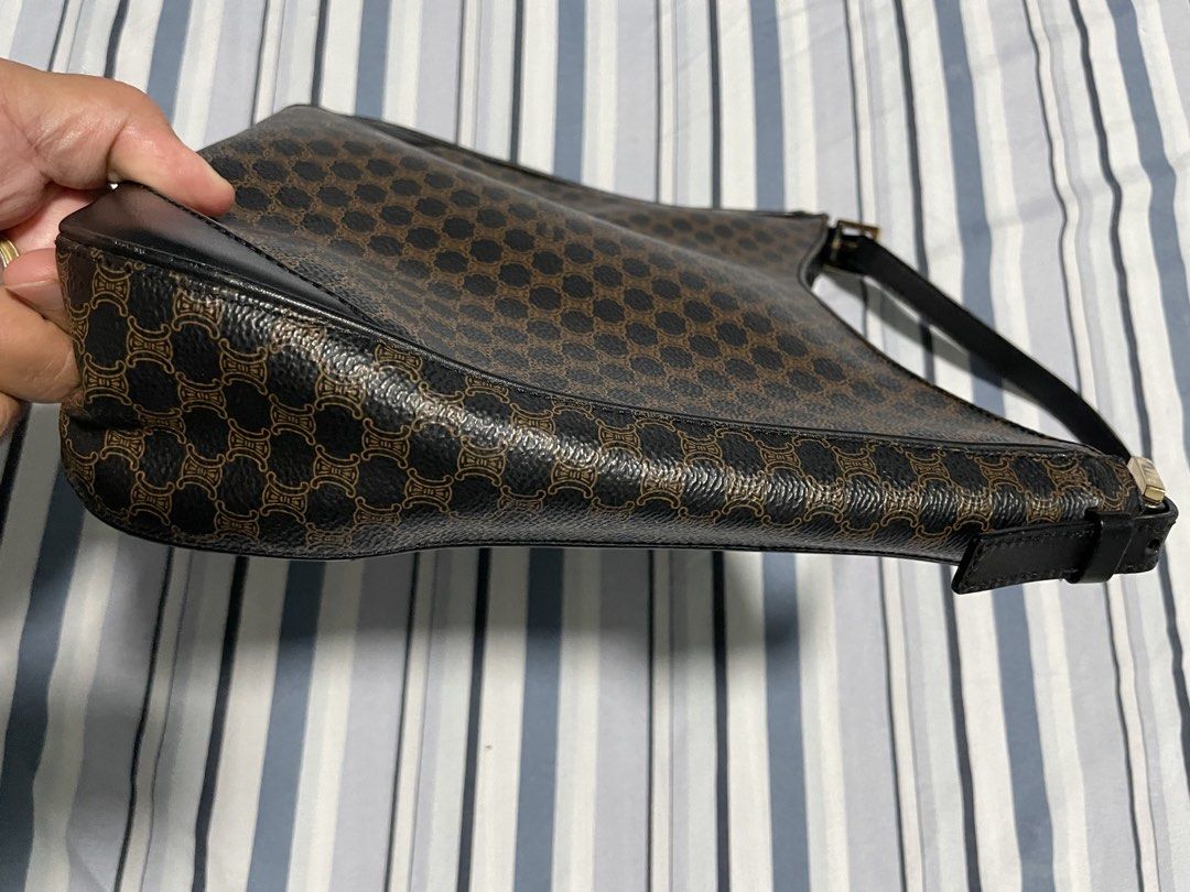 Celine Macadam Hobo Bag (Category: Luxury Bags & Wallets) located in Calapan. Submitted by lucasthrifts (Listing ID 1452607566, Image 2). Description: - Brand: Celine - Model: Macadam - Type: Hobo Shoulder Bag - Design: Iconic Macadam print - Condition: Great - Color: Brown/Black -Issue: Leather Sling cracks but still sturdy .
