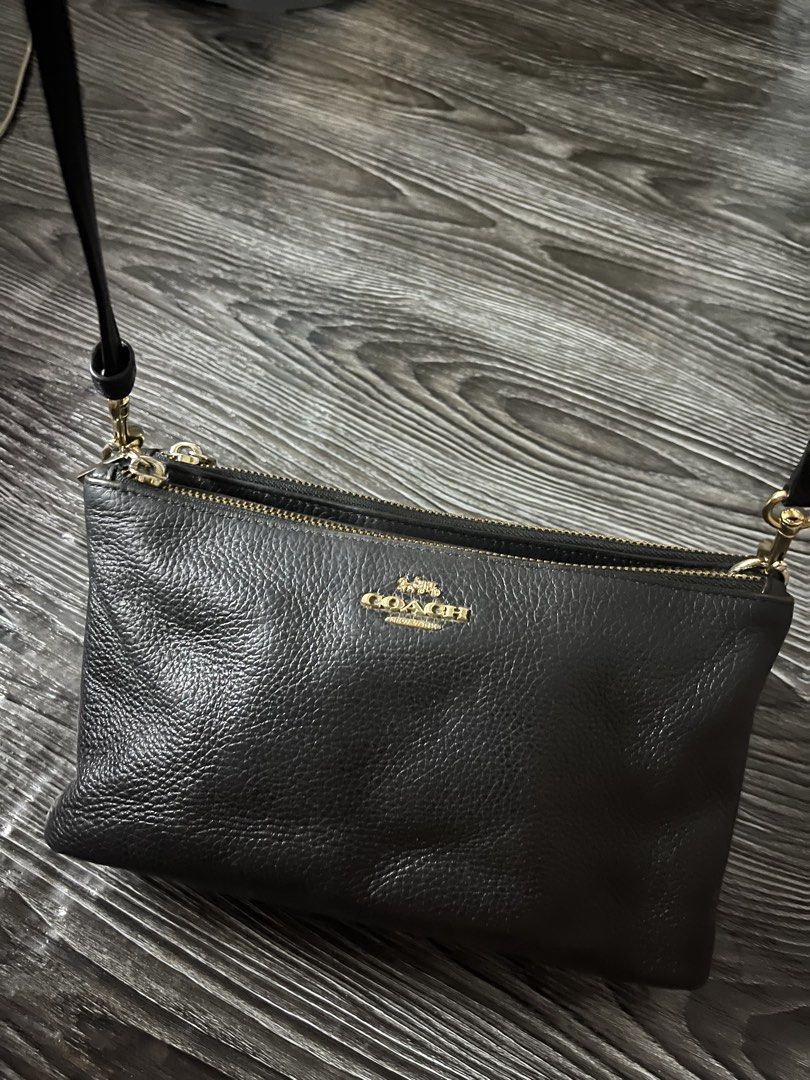 Coach Black Leather Double Zip Crossbody Bag (Category: Luxury Bags & Wallets) located in Manila. Submitted by merryjoyan39637 (Listing ID 1452615188, Image 3). Description: Designed to be durable, this crossbody bag from Coach is a prized buy. Comfortable and easy to carry, this leather creation comes in a black hue with the brand logo detail on the front. It has an adjustable shoulder strap and double zip closures that open to canvas insides fo