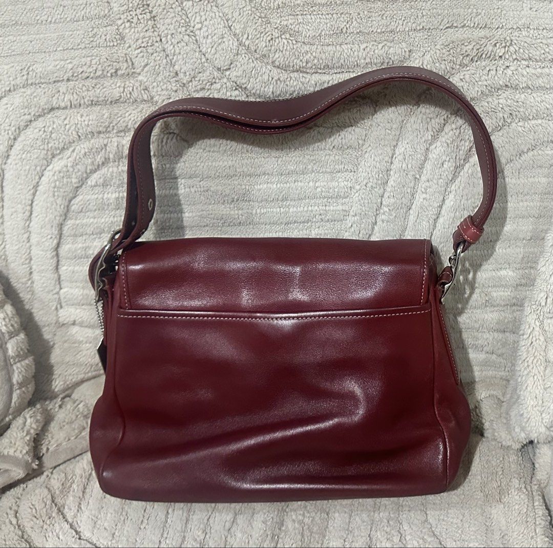 Coach Burgundy Leather Shoulder Bag (Category: Luxury Bags & Wallets) located in Quezon City. Submitted by marengcondo (Listing ID 1452616312, Image 2). Description: MAJOR DECLUTTERING ONGOING - Authentic classic burgundy leather shoulder bag by Coach. - Lined with signature Coach print. - Elegant silver hardware accents. - Adjustable strap with buckle for customized fit. - Ideal for everyday wear. - with original dustbag.