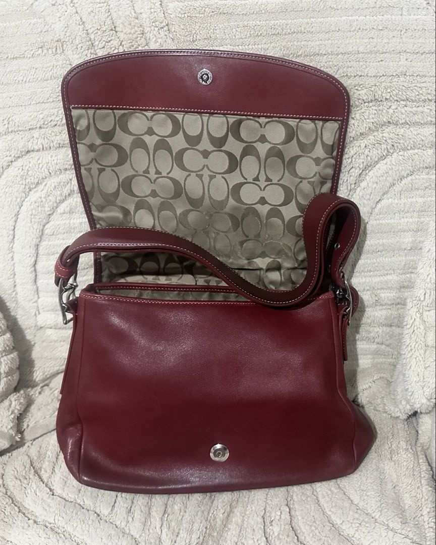 Coach Burgundy Leather Shoulder Bag (Category: Luxury Bags & Wallets) located in Quezon City. Submitted by marengcondo (Listing ID 1452616312, Image 3). Description: MAJOR DECLUTTERING ONGOING - Authentic classic burgundy leather shoulder bag by Coach. - Lined with signature Coach print. - Elegant silver hardware accents. - Adjustable strap with buckle for customized fit. - Ideal for everyday wear. - with original dustbag.