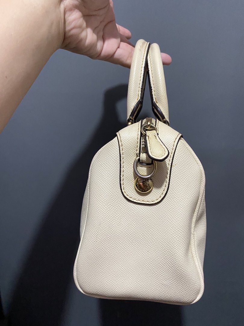Coach Cream Pebbled Leather Satchel Bag (Category: Luxury Bags & Wallets) located in Batangas. Submitted by bagstolove3.0 (Listing ID 1452582964, Image 2). Description: - Cream colored Coach satchel bag - Pebbled leather exterior - Gold hardware accents - Top handles for comfortable carrying - Secure zip closure - Includes original Coach hangtag - Spacious interior, ideal for daily essentials - Versatile for everyday use No sling.
