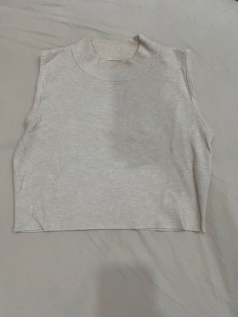 Cream Ribbed Mock Neck Sleeveless Crop Top (Category: Sleeveless) located in Quezon City. Submitted by goatedls (Listing ID 1452640862, Image 1). Description: - Cream colored sleeveless top - Ribbed knit material - Mock neck design - Cropped length - Ideal for layering or wearing on its own.