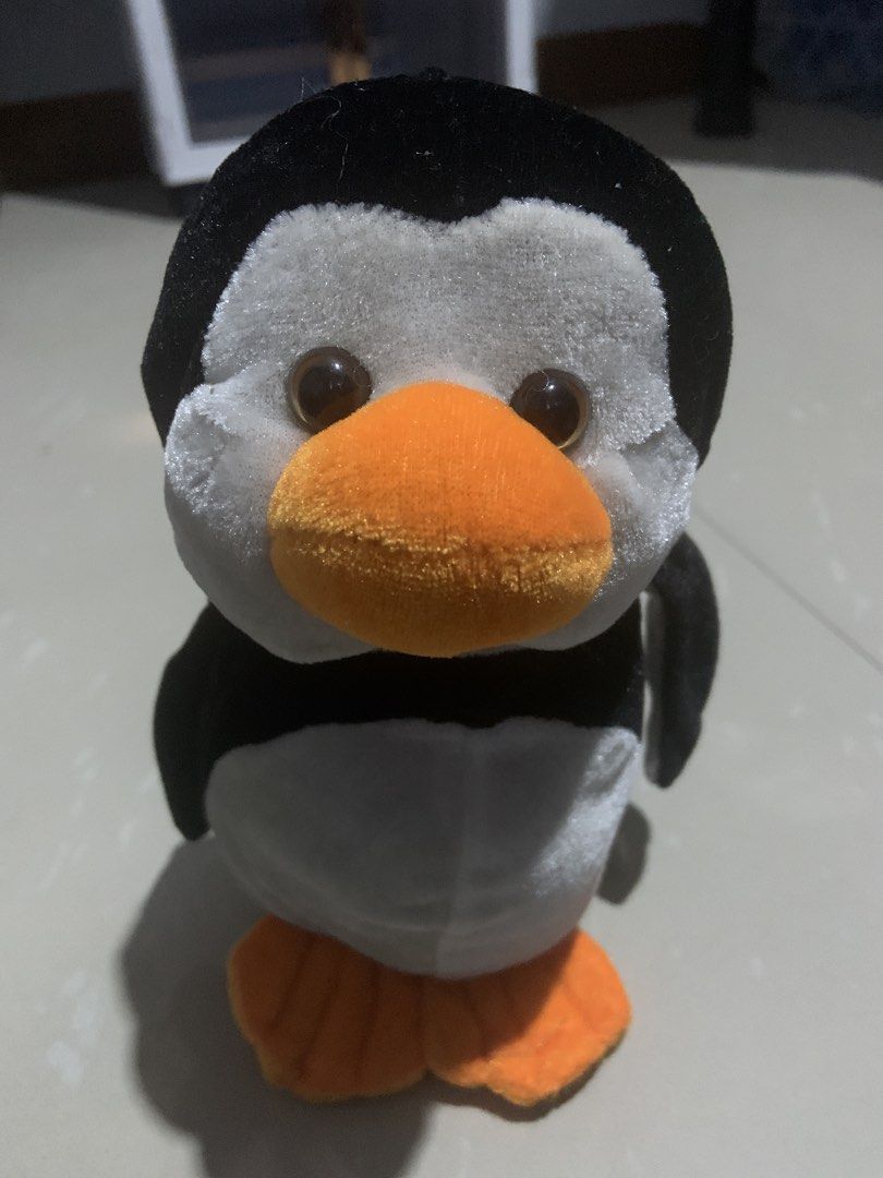 Cute Penguin Plush Toy (Category: Plushies & Soft Toys) located in Cavite. Submitted by krydeclutter (Listing ID 1452599540, Image 2). Description: - Soft and cuddly penguin plush toy - Features an orange beak and feet - Ideal for children or as a charming decoration - Approximately the size of a smartphone - Eager to find its new loving home!.