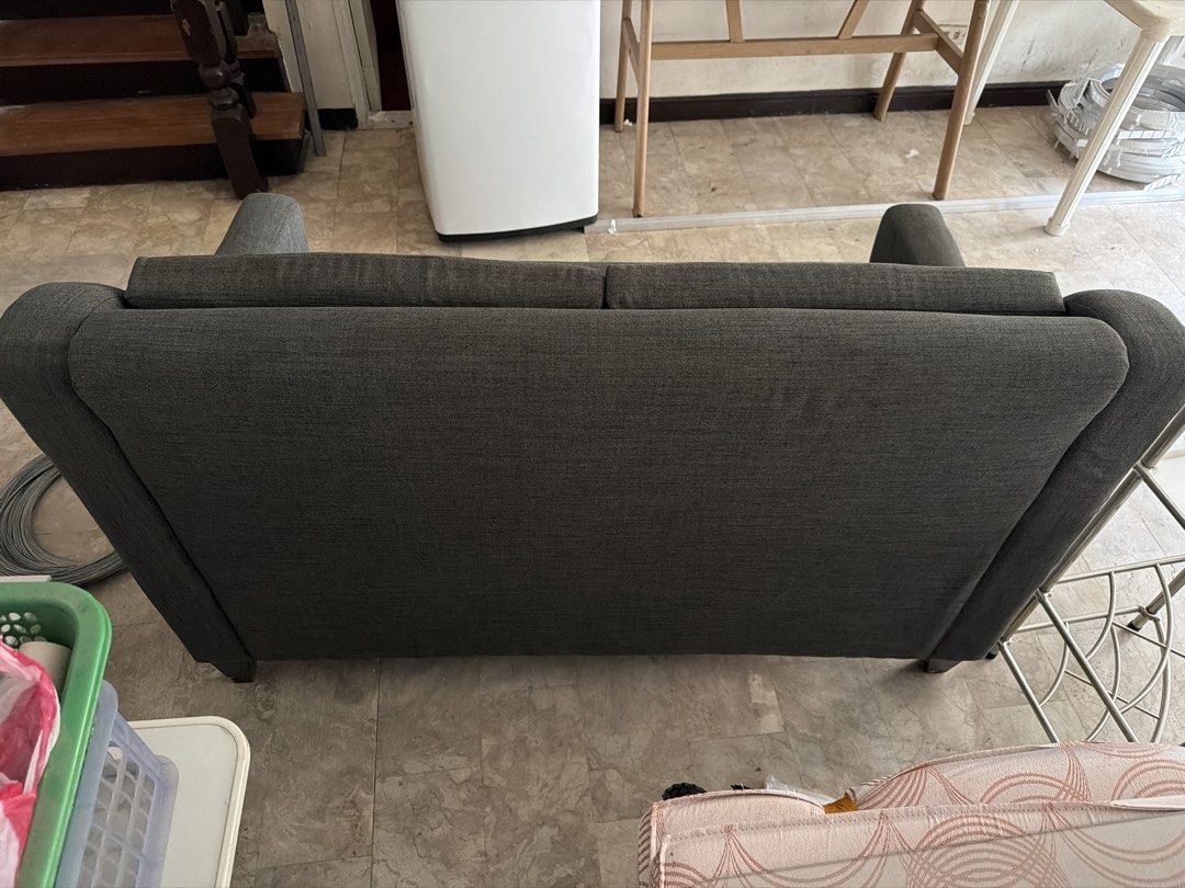 Dark Grey Two-Seater Sofa with Button Tufting (Category: Sofas) located in Manila. Submitted by uys958 (Listing ID 1452510181, Image 3). Description: - Dark grey two-seater sofa - Textured weave fabric - Button tufted back cushions - Dark wood legs - Simple, classic design - Ideal for living room or study.