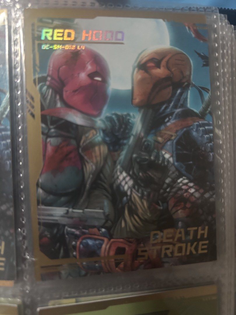 DC Comics Red Hood & Deathstroke Trading Card (Category: Raw Singles) located in Manila. Submitted by dckardz (Listing ID 1452554479, Image 1). Description: - DC Comics Trading Card - Features Red Hood and Deathstroke - Holographic finish - Part of the DC-SM-012 L4 set - Perfect collectible for DC fans.