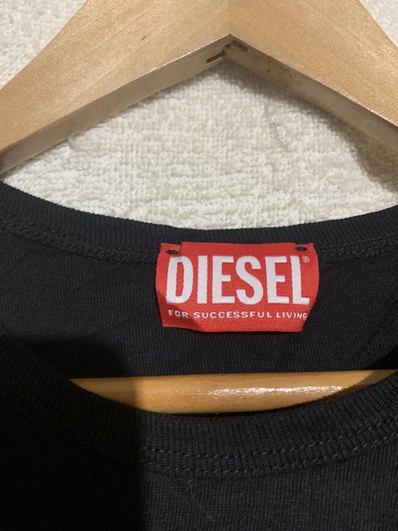 Diesel Black Distressed T-Shirt (Category: Activewear) located in Iloilo. Submitted by johnpullan30303 (Listing ID 1452682584, Image 3). Description: - Authentic Diesel t-shirt - Features a unique distressed cutout detail on the front - "Made for successful living" slogan - Authenticity verifiable via QR code on tag - Ideal for casual wear.