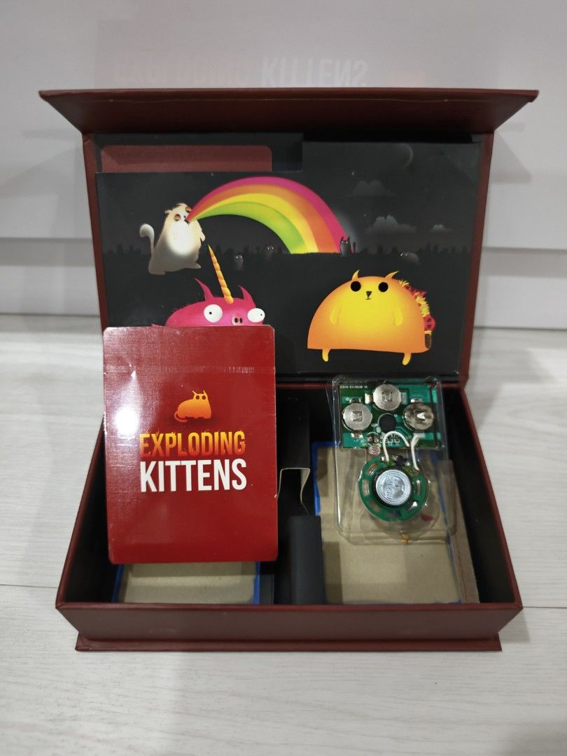 Exploding Kittens Card Game (Category: Board Games & Puzzles) located in Singapore. Submitted by mizmi (Listing ID 1452535986, Image 3). Description: Original launch edition. Brand new in box, card sealed and unopened. Clearing store. First come first served, self collect or Carousell SPX delivery paid by buyer. - Exploding Kittens: The card game of kitty-powered Russian Roulette! - Strategic gameplay: Draw cards, avoid the Exploding Kitten. - De