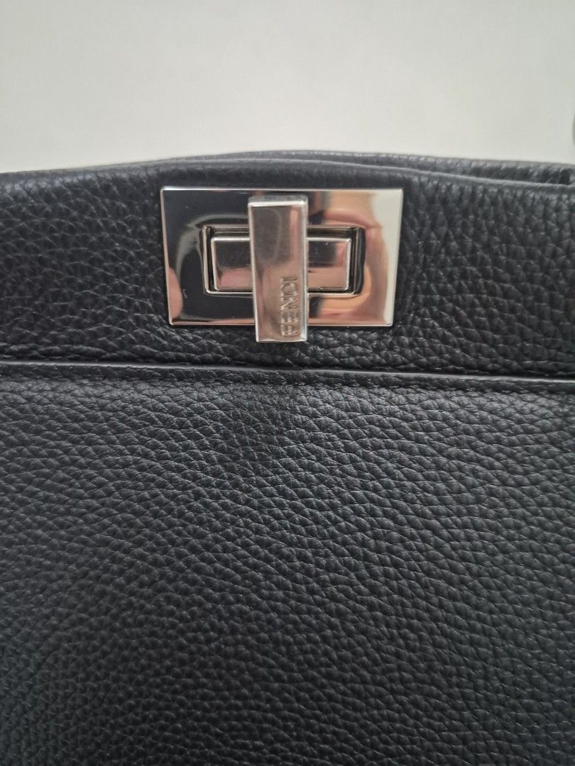Fendi Mini Peek-A-Boo (Category: Luxury Bags & Wallets) located in Quezon City. Submitted by trachenburg (Listing ID 1452685351, Image 2). Description: - Genuine black grained leather - Secure silver hardware clasp closure featuring the iconic Fendi lock - Detachable strap with a stylish buckle detail. - Classic and iconic Fendi Bag - Coded, Self Authenticated/NGA - Clean interior.