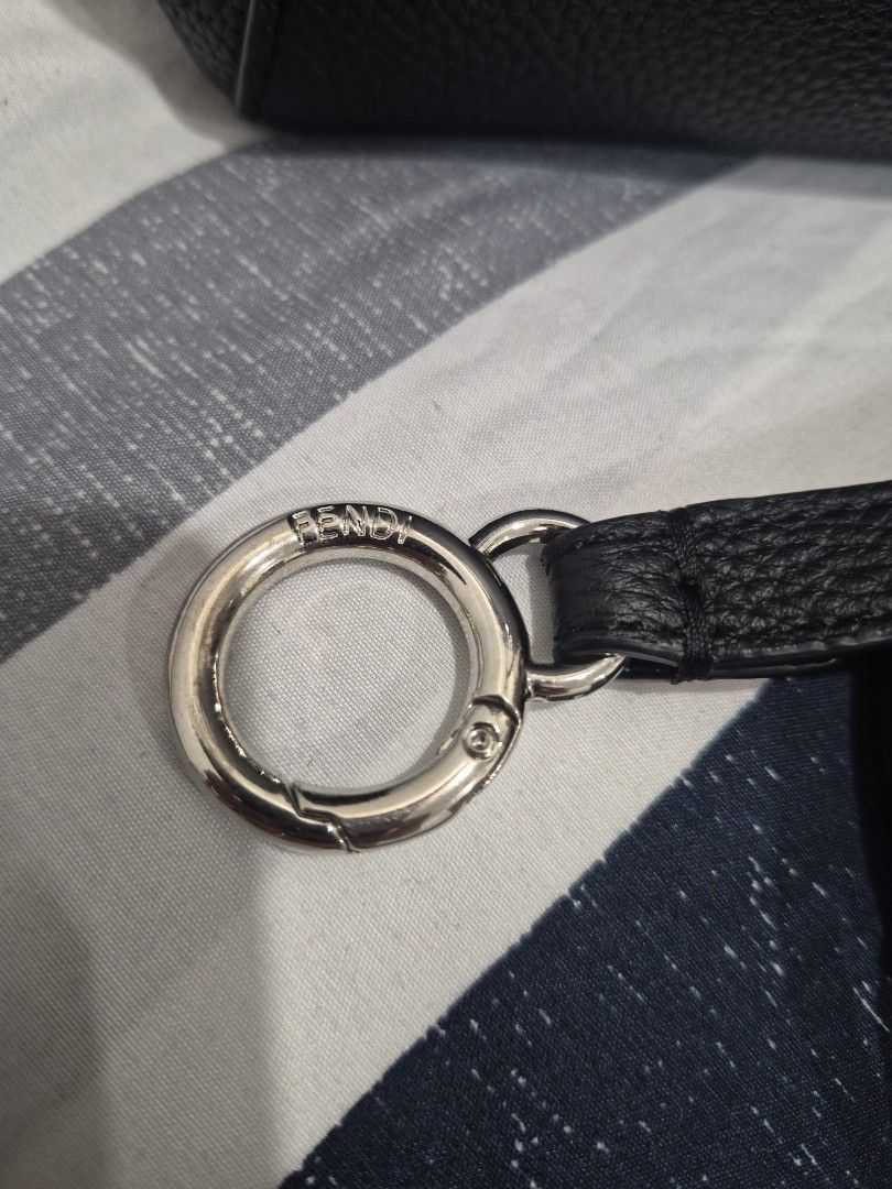 Fendi Mini Peek-A-Boo (Category: Luxury Bags & Wallets) located in Quezon City. Submitted by trachenburg (Listing ID 1452685351, Image 3). Description: - Genuine black grained leather - Secure silver hardware clasp closure featuring the iconic Fendi lock - Detachable strap with a stylish buckle detail. - Classic and iconic Fendi Bag - Coded, Self Authenticated/NGA - Clean interior.