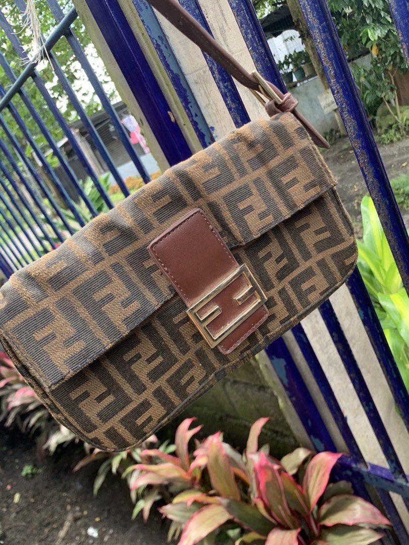 Fendi Zucca Canvas Shoulder Bag (Category: Luxury Bags & Wallets) located in Polomolok. Submitted by domingthriftclothes (Listing ID 1452643653, Image 2). Description: - Classic Fendi Baguette bag - Iconic Zucca print - Brown and black canvas with leather trim - Gold hardware detail on front buckle - Adjustable leather strap - Great for everyday use - A timeless piece.