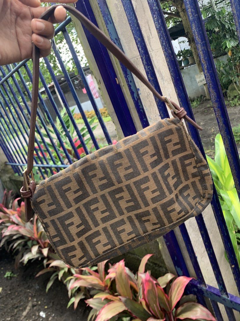 Fendi Zucca Canvas Shoulder Bag (Category: Luxury Bags & Wallets) located in Polomolok. Submitted by domingthriftclothes (Listing ID 1452643653, Image 3). Description: - Classic Fendi Baguette bag - Iconic Zucca print - Brown and black canvas with leather trim - Gold hardware detail on front buckle - Adjustable leather strap - Great for everyday use - A timeless piece.
