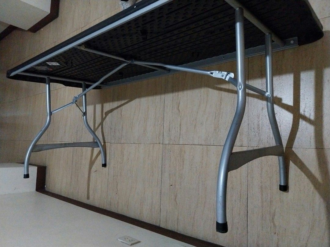 Folding Table - Durable Plastic Top, Metal Legs (Category: Tables & Sets) located in Makati City. Submitted by 88acres (Listing ID 1452529317, Image 3). Description: - Sturdy folding table - Dark grey plastic top - Silver metal legs - Folds flat for easy storage - Ideal for events, extra workspace, or dining - Legs feature protective rubber caps - we have ten pcs available.